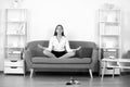 Businesswoman accountant in formal wear doing yoga exercise on sofa at workplace in office. Employee feel balance Royalty Free Stock Photo