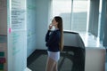Businesswoman analyzing data on whiteboard in modern office, deep in thought Royalty Free Stock Photo