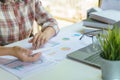 Businesswoman analyzing financial reports with calculator. Business financial and accounting concept. Royalty Free Stock Photo