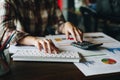 Businesswoman analyzing financial reports with calculator and typing on modern computer keyboard at office. Business analytics Royalty Free Stock Photo