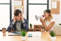 Businesswoman angry shouting her partner using megaphone at the office Royalty Free Stock Photo