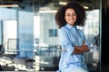 Businesswoman with arms crossed inside office at workplace, woman smiling and looking at camera, female worker with Royalty Free Stock Photo