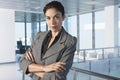 Businesswoman With Arms Crossed In Office Corridor Royalty Free Stock Photo
