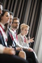 Businesswoman asking questions during seminar in convention center Royalty Free Stock Photo