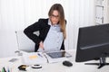 Businesswoman With Backpain Sitting On Chair Royalty Free Stock Photo