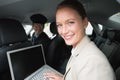 Businesswoman being chauffeured while working Royalty Free Stock Photo