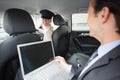 Businesswoman being chauffeured while working Royalty Free Stock Photo