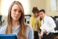 Businesswoman Being Gossiped About By Colleagues In Office