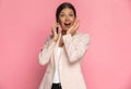 Businesswoman being happily surprised by some news on the phone