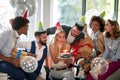 Businesswoman blowing candles on her birthday cake Surpise birthday party in the office Royalty Free Stock Photo