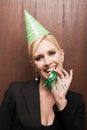 Businesswoman blowing party horn blower Royalty Free Stock Photo