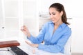 Businesswoman in a blue blouse is making her nails at desk and g Royalty Free Stock Photo