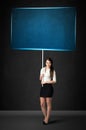 Businesswoman with blue board Royalty Free Stock Photo