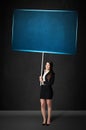 Businesswoman with blue board Royalty Free Stock Photo