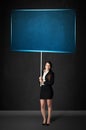 Businesswoman with blue board Royalty Free Stock Photo