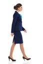 Businesswoman In Blue Suit Walking Side View