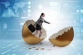 Businesswoman breaking out of golden egg