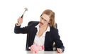 Businesswoman breaking a piggybank