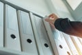 Businesswoman browsing through ring binder file documentation archives Royalty Free Stock Photo