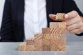 Businesswoman building steps with wooden blocks at table. Career ladder