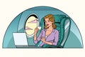 Businesswoman in business class of the aircraft works at a lapto