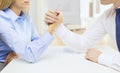 Businesswoman and businessman arm wrestling Royalty Free Stock Photo