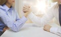 Businesswoman and businessman arm wrestling Royalty Free Stock Photo