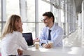 Businesswoman and businessman at a meeting, smiling Royalty Free Stock Photo