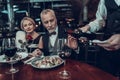 Waiter pours wine and Businessman stops him Royalty Free Stock Photo