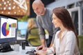 Businesswoman and businessman working together at the office