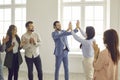 Businesswoman and businesswoman giving double high five at office meeting or at business training. Royalty Free Stock Photo