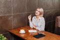 Businesswoman in cafe with coffee and notebook