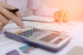 Businesswoman calculate about cost and charts report on table, calculator on desk of financial planing. Finance concepts. Royalty Free Stock Photo