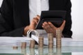 Businesswoman Calculating Invoice With Coins On Desk Royalty Free Stock Photo