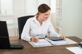 Businesswoman Calculating Invoice Royalty Free Stock Photo