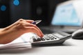 Businesswoman with calculator at night office Royalty Free Stock Photo