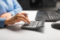 Businesswoman with calculator at night office Royalty Free Stock Photo