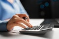 Businesswoman with calculator at night office Royalty Free Stock Photo