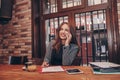 Businesswoman calling on mobile phone and taking notes Royalty Free Stock Photo