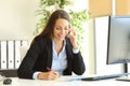 Businesswoman calling on phone and taking notes Royalty Free Stock Photo