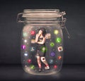 Businesswoman captured in a glass jar with colourful app icons c