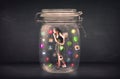 Businesswoman captured in a glass jar with colourful app icons c