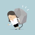 Businesswoman carrying a big rock.