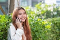 Businesswoman in casual cloth talking on mobile phone outside of Royalty Free Stock Photo