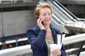 Businesswoman on cellphone walking while talking on smart phone. Happy smiling Caucasian business woman busy. Image from Madrid. Royalty Free Stock Photo