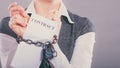 Businesswoman with chained hands holding contract