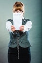 Businesswoman with chained hands holding contract