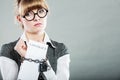 Businesswoman with chained hands holding contract