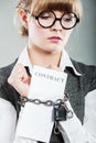 Businesswoman with chained hands holding contract