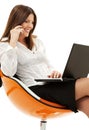 Businesswoman in chair with laptop and phone Royalty Free Stock Photo